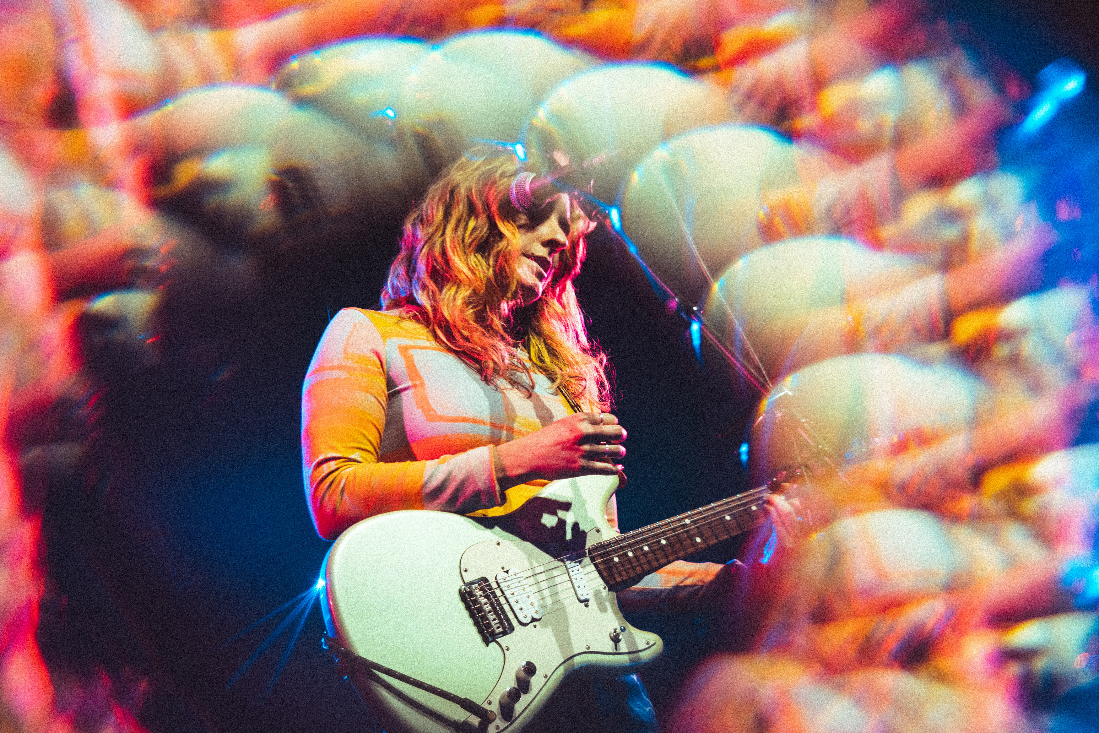 Merpire playing guitar on stage