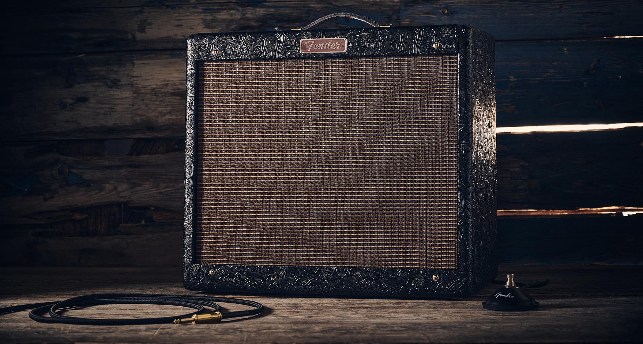Fender Blues Junior IV 30th Anniversary: the classic combo is refinished with a touch of cowboy western flair, and is here photographed against some weathered floorboards in close-up